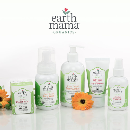 Five Earth Mama Organics baby care products on a white counter