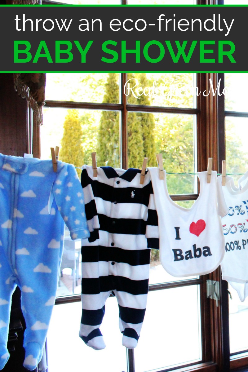 Baby clothes hanging on a clothesline in a living room for baby shower decorations