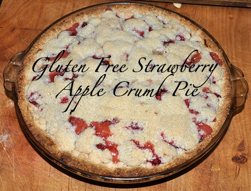 Gluten free strawberry apple crumble pie on a wood cutting board