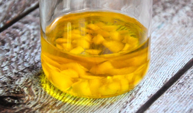 Close up of garlic and olive oil in a glass jar
