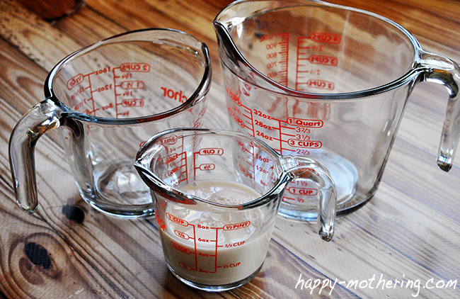 Three Anchor Hocking glass measuring cups on a wood table