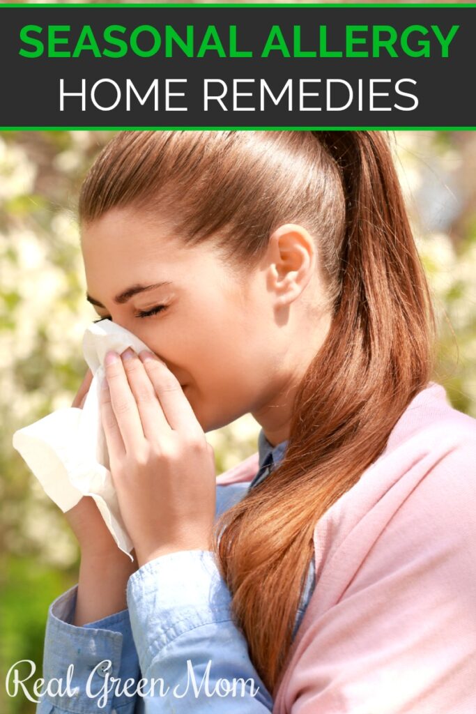 Woman sneezing into a tissue with a white flowering tree behind her