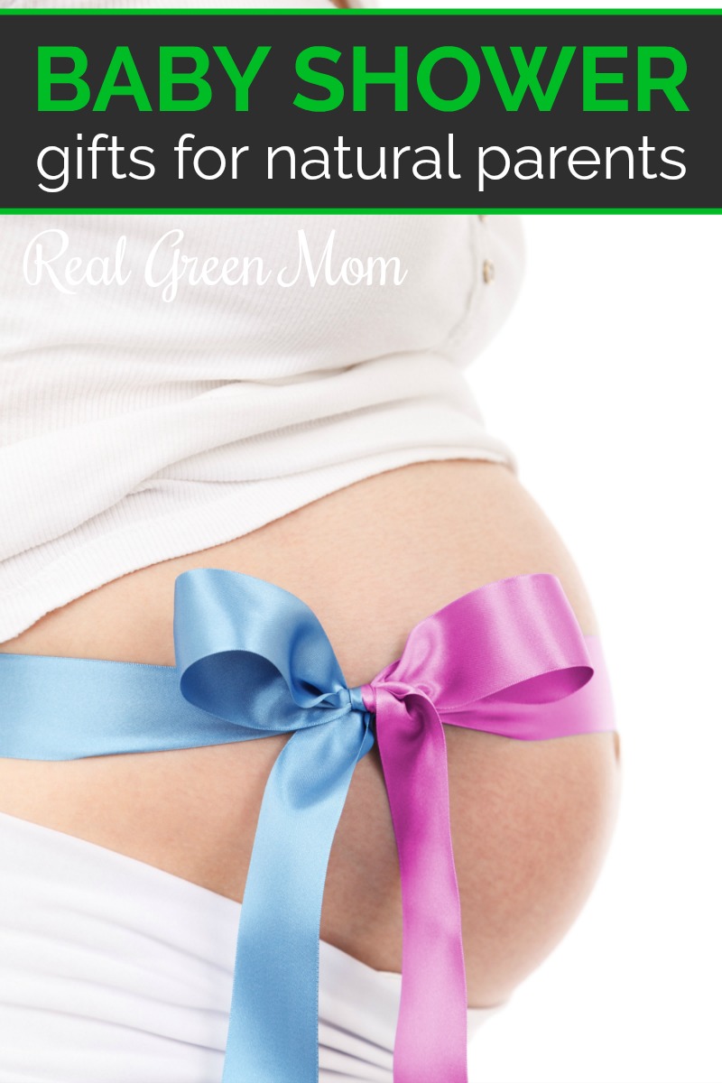 Pregnant woman wearing white with a pink an blue ribbon tied around her belly