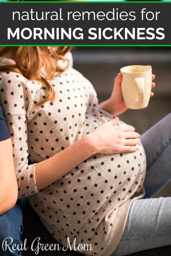 Pregnant woman with one hand on her belly and a teacup in the other hand
