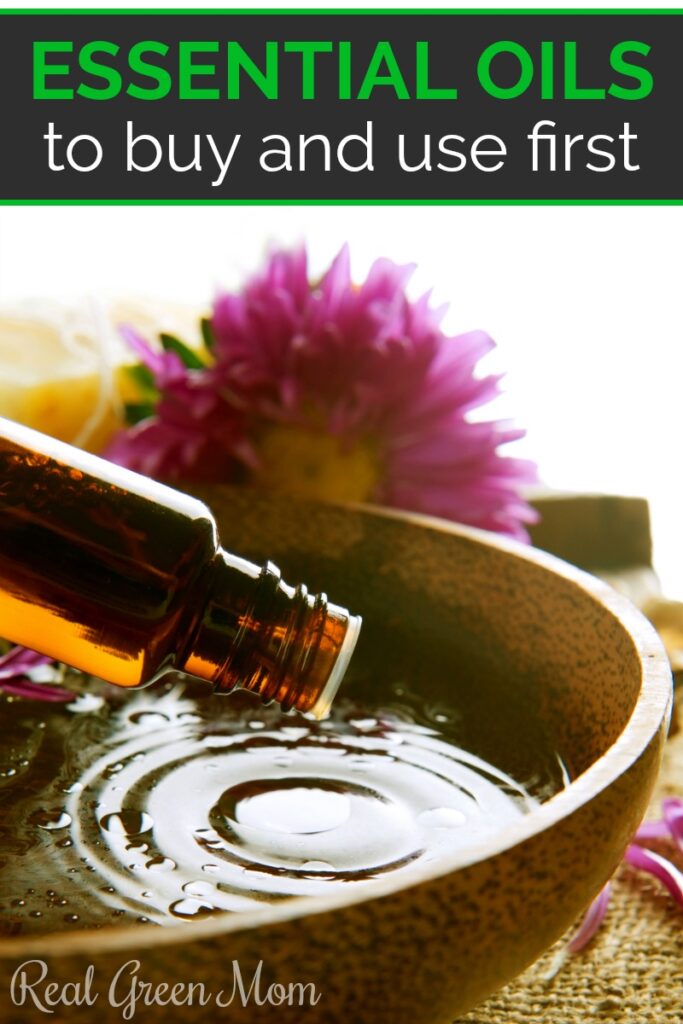 Essential oils being poured into a bowl with a pink flower in the backround