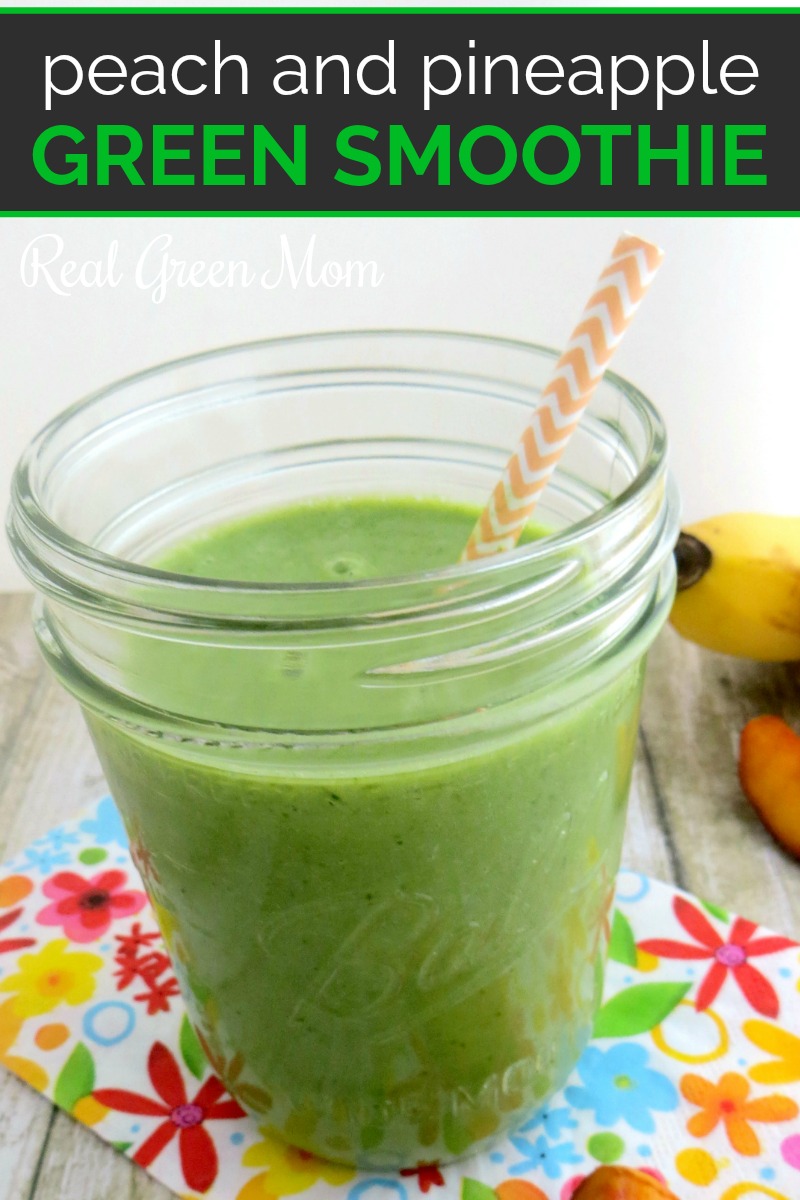 Peach and pineapple green smoothie in glass mason jar with yellow paper straw