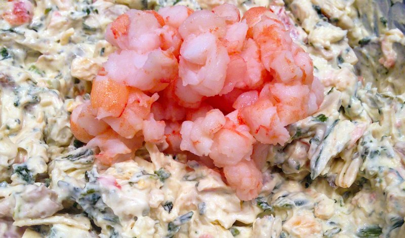 Chopped shrimp added to bowl of kale and cheese dip mixture