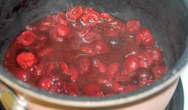Cherries simmering in a saucepan