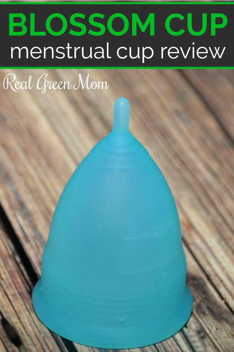 Blossom Cup menstrual cup standing up on a wood table