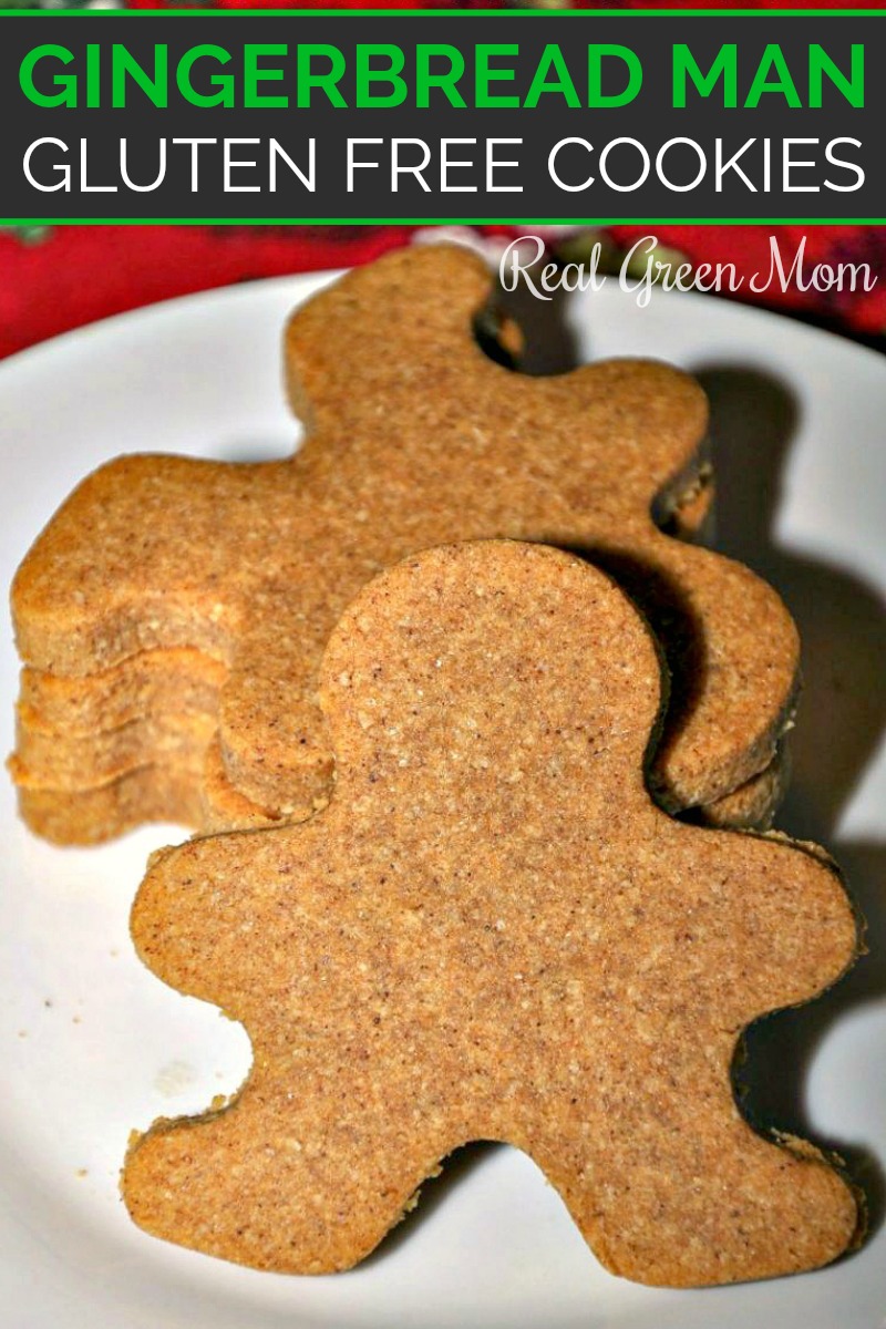 A stack of gingerbread man cookies on a white plate with one leaning up against the rest with a red background