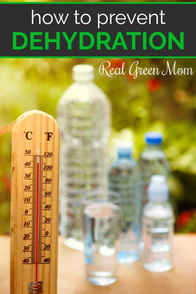 Several water bottles on a table with a thermometer showing a high temperature