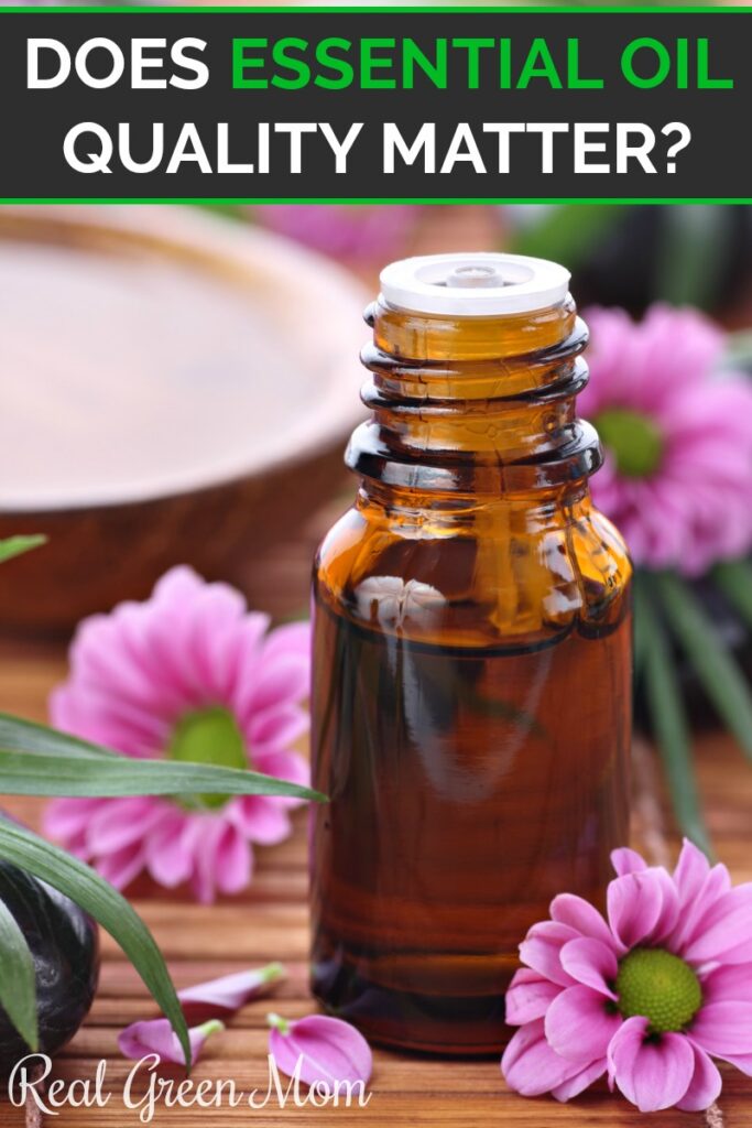 Amber essential oil bottle on table with pink flowers