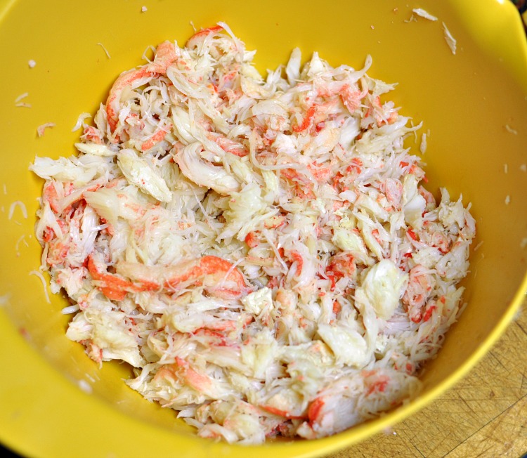 Shelled crab meat in a yellow mixing bowl