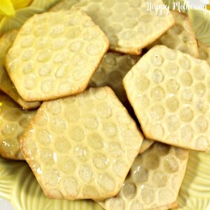 Close up of homemade honeycomb shortbread cookies on a yellow serving plate