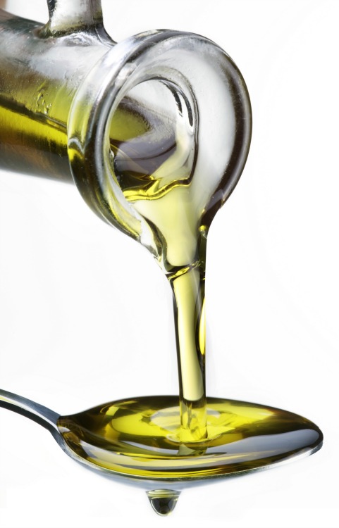 Olive oil being poured into a spoon