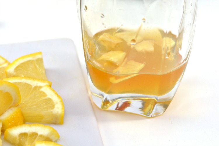 Ginger added to glass with honey and apple cider vinegar