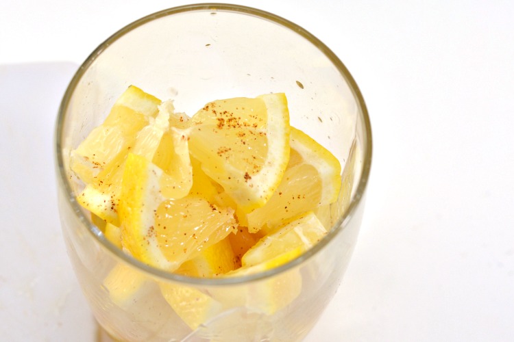 Cayenne pepper sprinkled over lemon wedges in glass