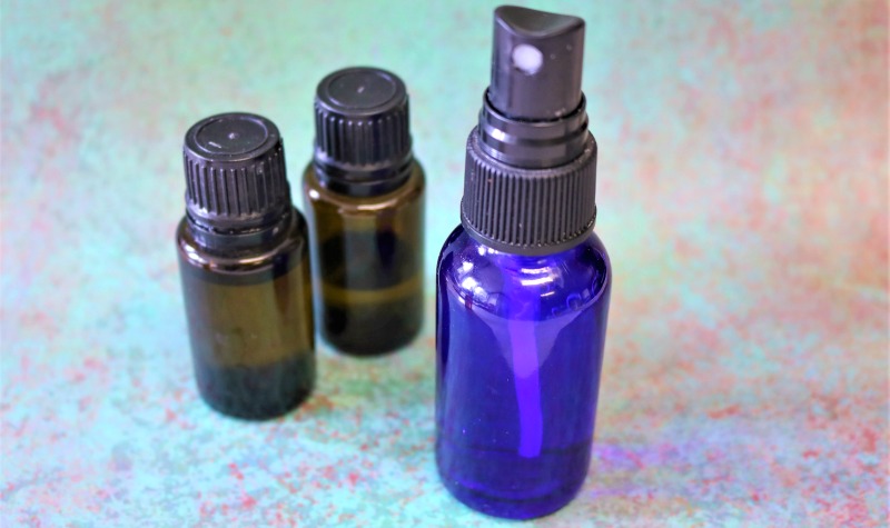 Blue spray bottle and two essential oil bottles