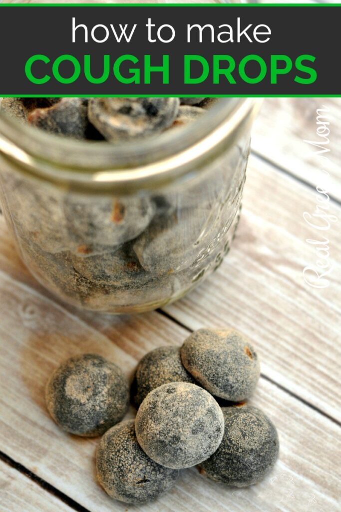 Pint sized mason jar full of homemade cough drops with a stack on the table next to it