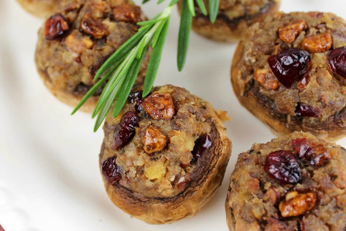 Close up of Sausage Stuffed Mushrooms appetizer on a white platter