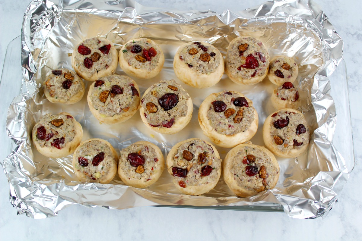 Sausage Stuffed Mushrooms on a foil lined baking sheet ready to be cooked