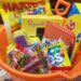 Orange sand bucket filled with Easter candy on a table
