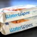 Two packages of WaterWipes stacked on a brown wood table